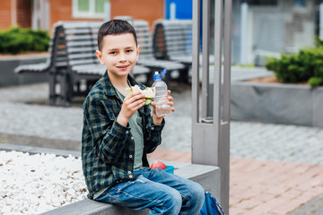 Primary school boy holding lunch box. Healthy eating concept for schoolchild.