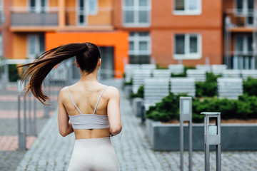 Fototapeta premium Beautiful day for sport activity. Photo of the back, brunette woman running.