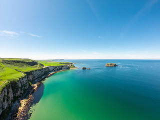 Carrick a Rede Rope Bridge in Ballintoy Northern Ireland. Aerial view on Cliffs and turquoise Atlantic Ocean water