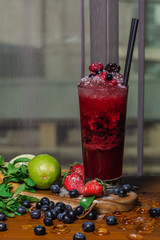 Summer berry Drink, Homemade Lemonade with berryes, strawberry, raspberry, blueberry, blackberry, mint, lime and crashed ice. Vertical view