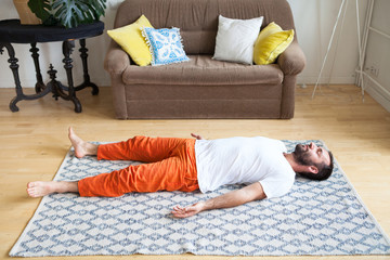 Man practicing yoga and meditation at home. A series of yoga poses. Lifestyle concept