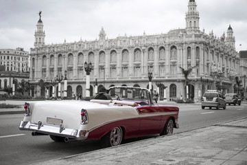 colorkey of red and white classic car in front of grand theatre in havana, cuba
