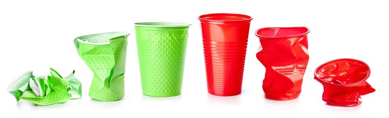 Green and red plastic cups isolated on white background, recyclable garbage