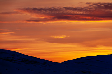 Fototapeta na wymiar Silhouette hills during sunset in the mountains of Funäsfjällen, Sweden. 