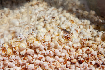 Popcorn is cooking. Simple background with sweets. Corn at the feast.