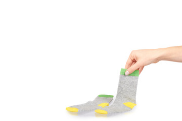 Hand with warm winter childrens socks, cute cotton clothes