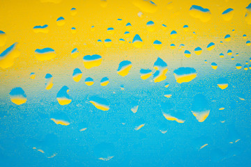 Fototapeta na wymiar water drops on blue yellow background