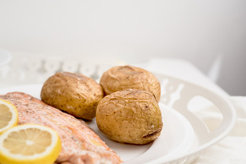 Salmon steak served with baked potato 