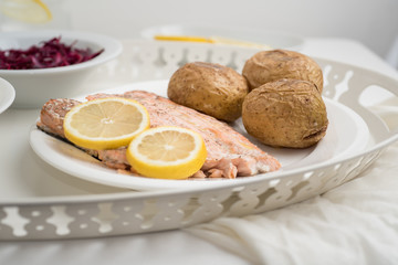 Salmon steak served with baked potato 