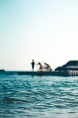 Floating platform in the sea, with teenagers having fun, out of focus - 278451932