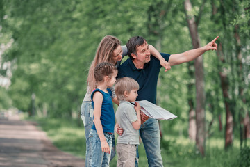 Fototapeta premium family with children discussing the route of travel on the map