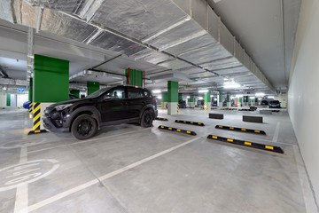 Modern underground parking garage with cars