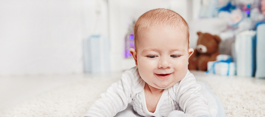 pretty baby lying on the carpet in the living room cozy
