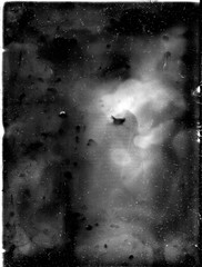A real, black and white large-format spoiled photo with dust and scratches. Glass photographic plate with scratches, dust, dirt, out of focus image.