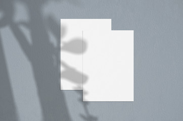 Blank white vertical paper sheet 5x7 inches with tree shadow overlay. Modern and stylish greeting card or wedding invitation mock up.