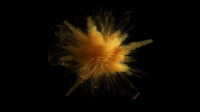 Super slow motion of gold yellow colored powder explosion isolated on black background. Super slow motion 3d render