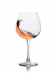 Glass of amber wine with splashes isolated on white.