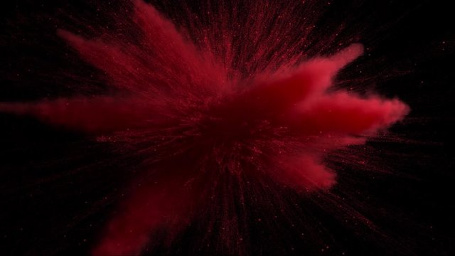 3d render of red powder explosion on black background. Slow motion movement with acceleration in the beginning.