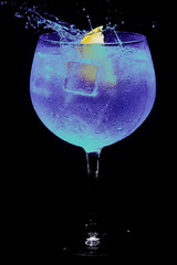 glass of gin tonic blue and lemon