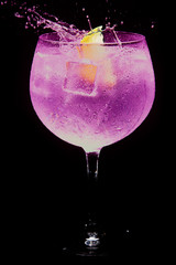 glass of gin tonic pink and lemon