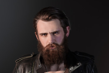 portrait of a brutal man in a leather jacket.