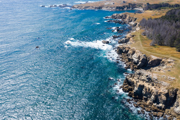 Seen from a bird's eye view, the Pacific Ocean washes against the rocky coast of Northern California in Sonoma. This beautiful area runs parallel to the famed Pacific Coast Highway.