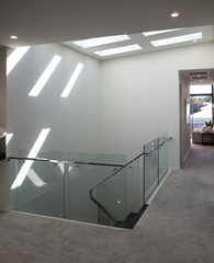 Modern staircase with bright sunlight through ceiling windows