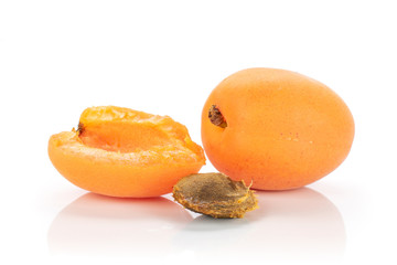 Group of one whole one half of meaty fresh deep orange apricot with a stone isolated on white background