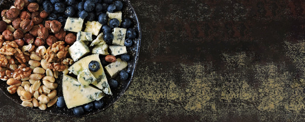Cheese plate with blue cheese, nuts and blueberries. Healthy snack. Keto diet