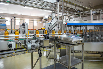 Conveyor belt or production line of juice on beverage plant or factory, modern computerized industrial equipment
