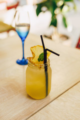 Summer cool drink with pineapple on a wooden table in a cafe.
