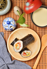 Seafood hand roll sushi on wooden plate