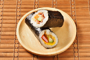 Seafood hand roll sushi on wooden plate