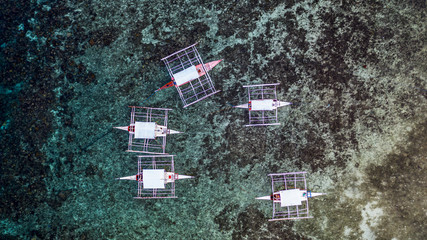 Aerial view traditional Philippines boats on coral reef, Filipino boats in the sea, Philippines.