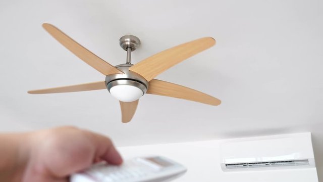 Flat air conditioner on white wall and ventilator fan in room, money saving electricity concept