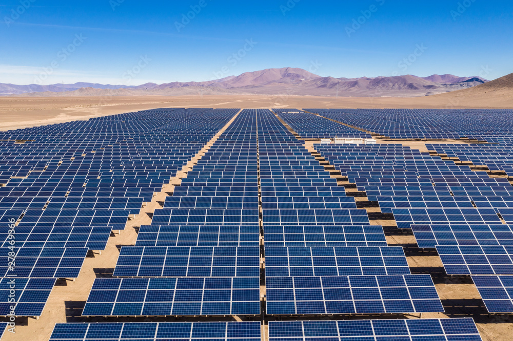 Wall mural aerial view of hundreds solar energy modules or panels rows along the dry lands at atacama desert, c