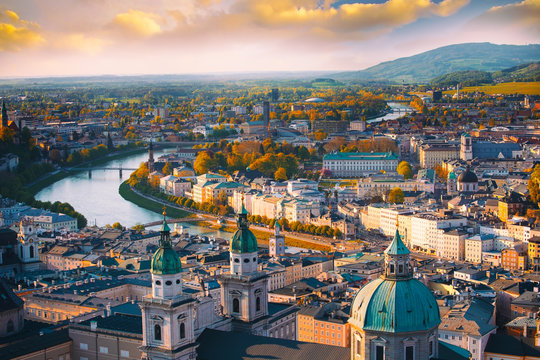 Beautiful of Aerial panoramic view in a Autumn season at a historic city of Salzburg with Salzach river in beautiful golden evening light sky and colorful of autumn at sunset, Salzburger Land, Austria