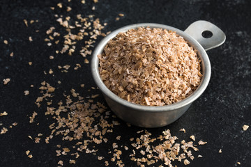 Wheat Bran Spilled from a Measuring Cup