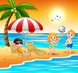 Obraz na płótnie Canvas Children playing at the beach on summer holidays
