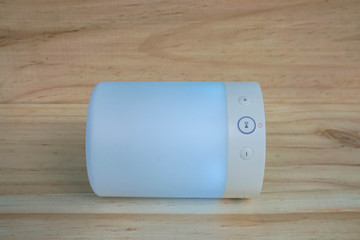 glowing modern wireless speaker in blue color with light function for music player