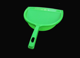green garbage cleaner isolated on black background