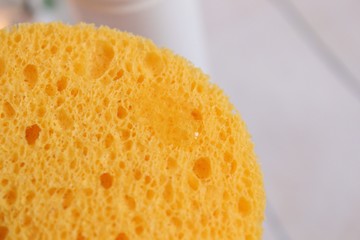 Facial wash sponge in a woman's hand
