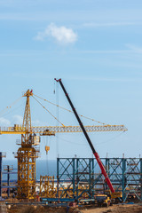 Concrete tanker and construction vehicle at construction site