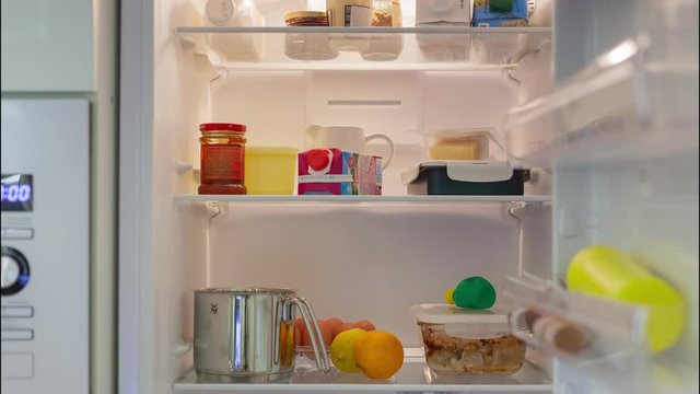 Products and food appear and fill fridge indoors
