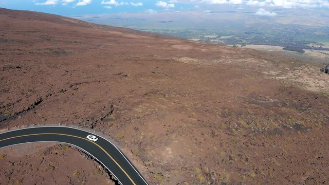 Aerial Tracking and Tilt Up Reveal of Main Road to Haleakala National Park and Volcano.
