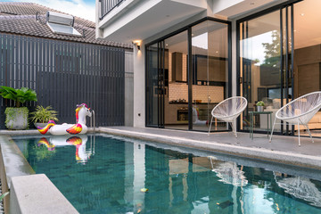 exterior home with swimming pool and floating unicorn in the house