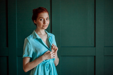 Sexy redhead girl unbuttons her dress flirts, seduces