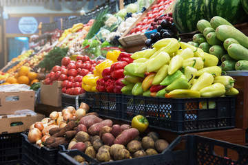 Vegetable farmer market counter: colorful various fresh organic healthy vegetables at grocery...