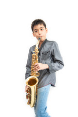 Little asian musician boy playing saxophone instrument