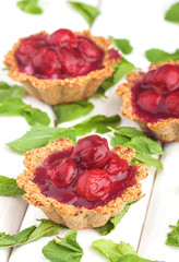 Sweet Desserts with red berries on wooden white background. Summer fruit desserts.